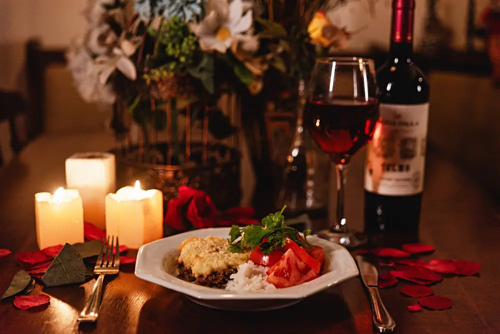 A candlelit dinner with a glass of red wine
