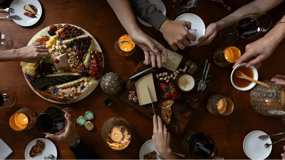 A cheese and charcuterie board shared around a table